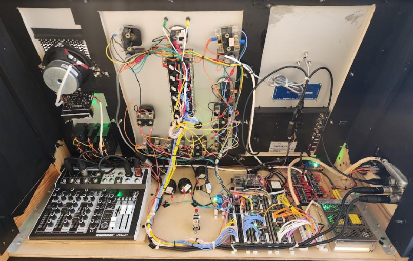 Exposed circuit boards, relays, mixing board, and power supplies